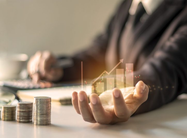 Financial growth graph on hand, business people are documenting office finance, financial ideas and loan investments.
